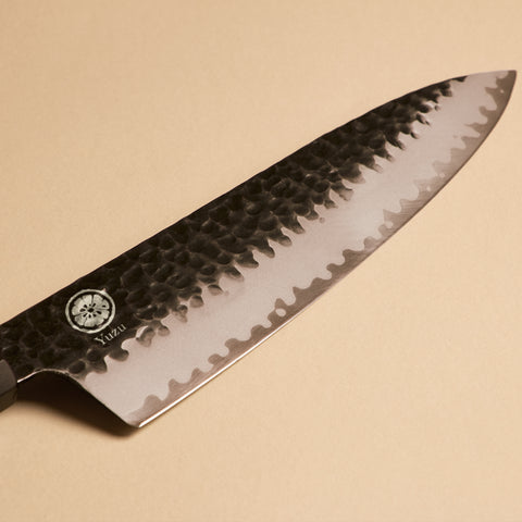 Close-up of Gyuto kurouchi hammered finish on AUS-10 steel blade