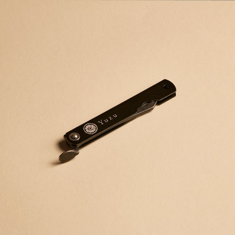 Higonokami pocket knife folded closed showing Yuzu branding