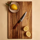 Yuzu Knives Japanese steel Petty paring knife on a walnut cutting board with lemons