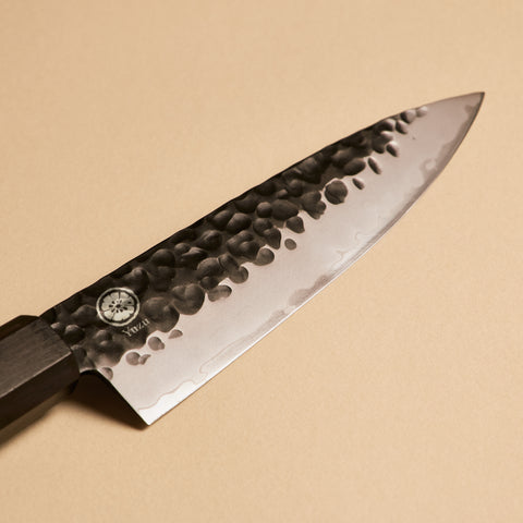 Close-up of Petty kurouchi hammered finish on AUS-10 steel blade