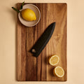 Gyuto saya knife sheath on a cutting board with lemons