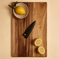 Petty saya knife sheath on a cutting board with lemons