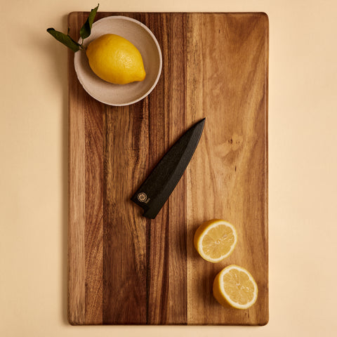 Petty saya knife sheath on a cutting board with lemons